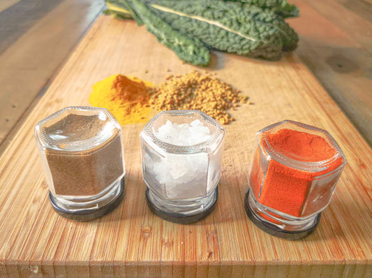 Magnetic spice jars sitting on a chopping board