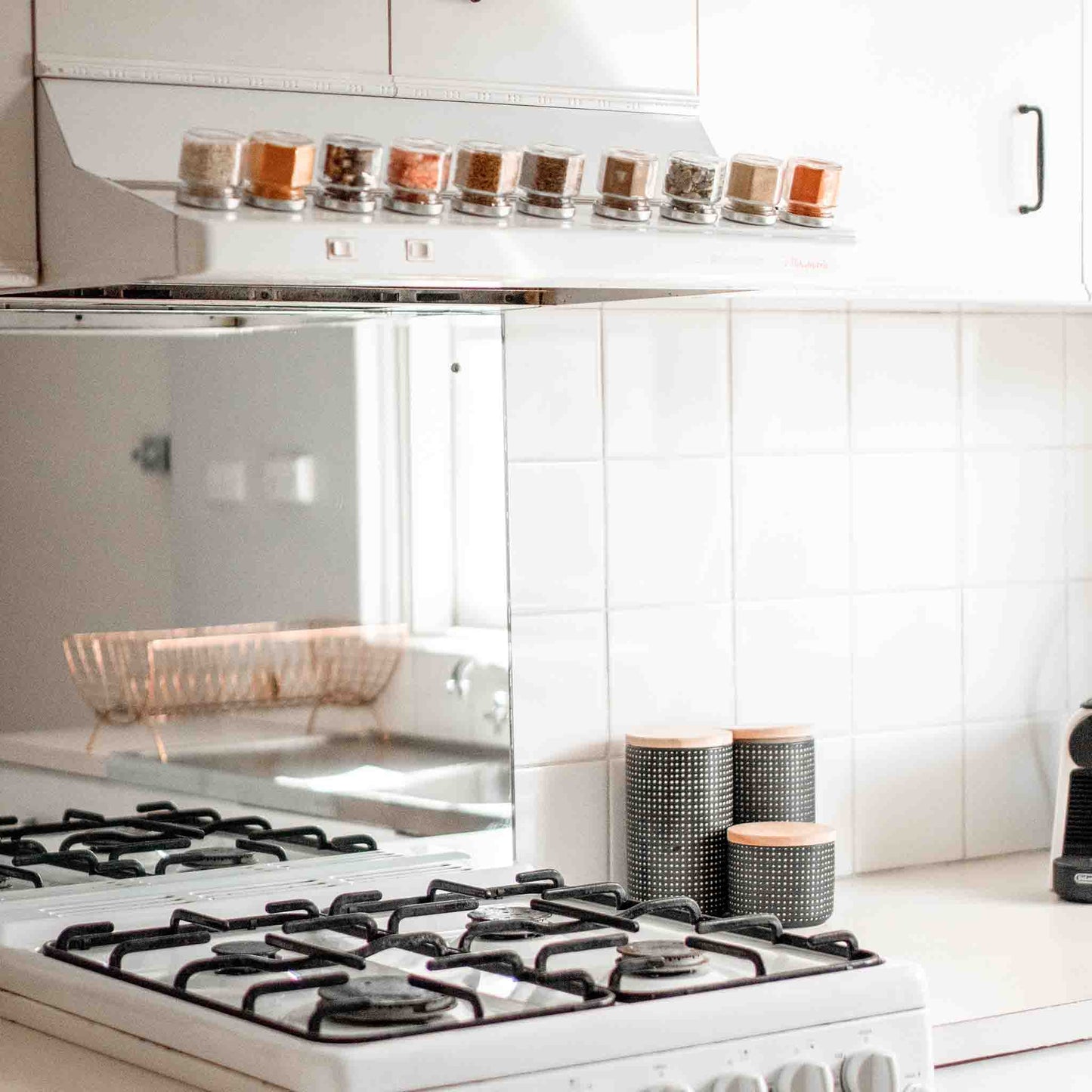 Magnetic spice jars attached to the topside of a rangehood